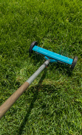 Hand scarifier for lawn in action. Manual tools for lawn maintenance activitiesの写真素材