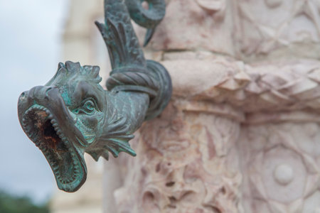 Fish-shaped bronze tap at Municipal building pillory, Sintra, Portugal. Major tourist destination of Greater Lisbon Regionの写真素材