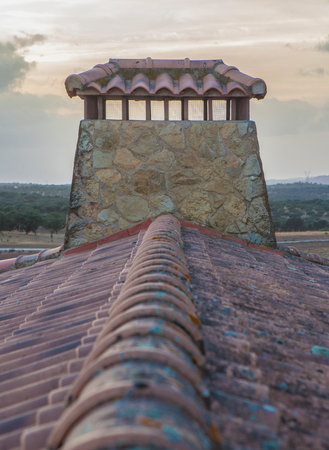 Gabled roof with masonry chimney in the center, Country house roofの写真素材