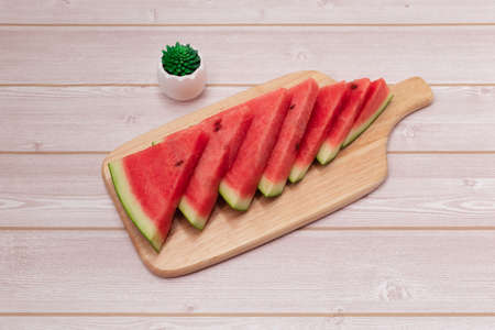 Sliced ââwatermelon in a wooden bowl on the table. (The sliced ââwatermelons on the table.)の写真素材