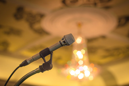 Microphone in conference room with defocused bokeh lights in background.CR2の写真素材