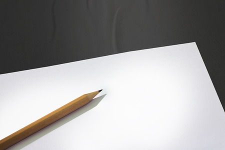 Blank paper with pencil on wHITE TABLEの写真素材