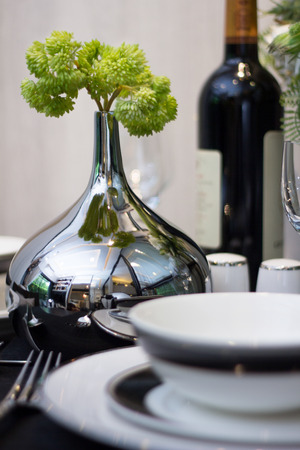 black and white table set on black dining  table and shiny vase at homeの写真素材
