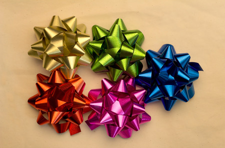 Collection of colorful bows with ribbons on beige backgroundの写真素材