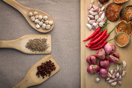 Various colorful spices on wooden table and wood plateの写真素材