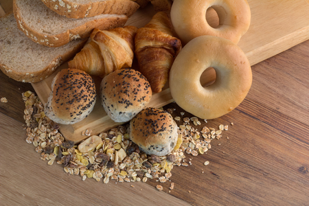 Different types of bread on the wood backgroundの写真素材