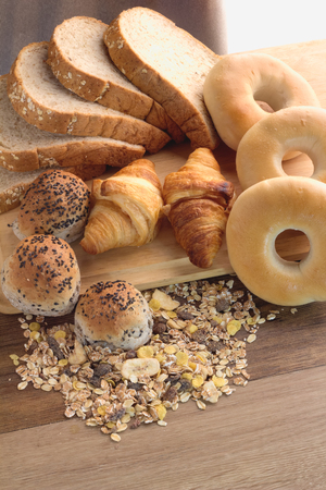 Different types of bread on the wood backgroundの写真素材