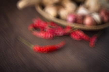 GINGER AND CHILI ON DARK WOOD BULR IAMGE FOR BACKGROUND USEの写真素材
