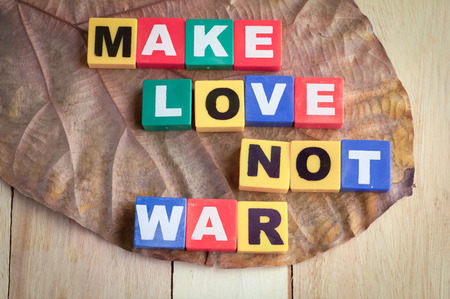 Wooden Blocks with the text make love not war on wooden backgroundの写真素材