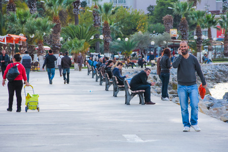 Young  men in the city main square with smartphone having a break Kusadasi Tulkey December 2014のeditorial素材
