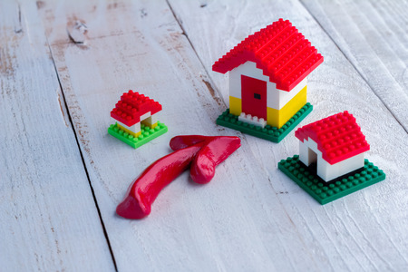 toy house and red arrow on wooden background : business conceptの写真素材