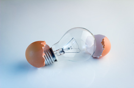 Innovation Bright Ideas Light Bulb Hatching From Egg Shell on white floorの写真素材