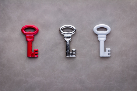 three keys red silver and white on grey background Concept of finding a solution.の写真素材