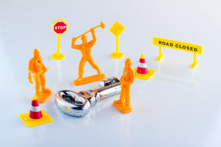 workmen figure making a key on white floor business success conceptの写真素材