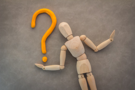 wood man with question mark business solution concept on grey backgroundの写真素材