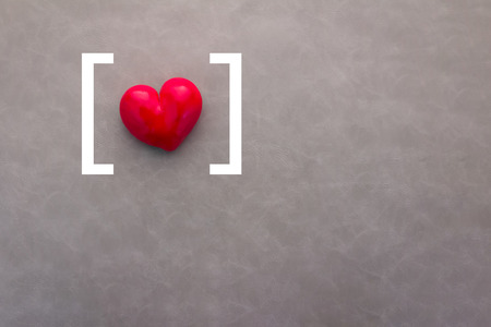 red heart with white signage on a grey background.の写真素材