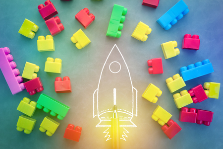 Flying rocket with colorful toy blocks creative conceptの写真素材