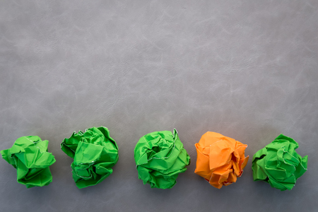 green and orange crumpled paper balls business idea concept.jpgの写真素材