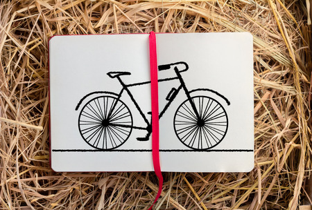sketch of bicycle on diary with hay texture backgroundの写真素材