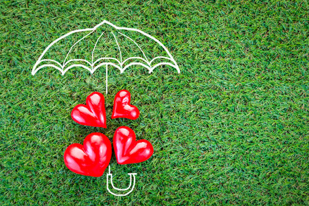 four red hearts on green grass field texture background love concept.jpgの写真素材