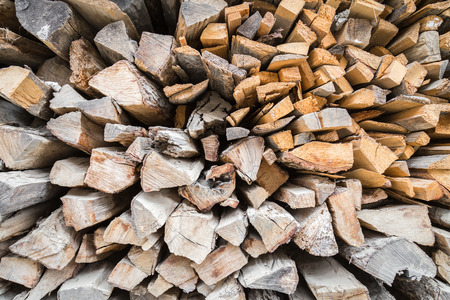 many raw firewood logs stacked texture background