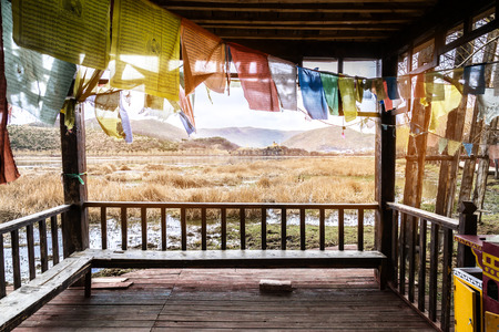 grass field landscape view from gazebo with tibet style in chinaの写真素材