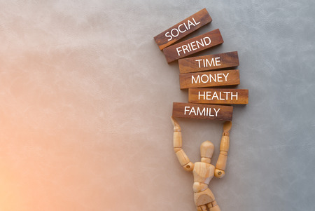 wooden man with wood block with word inside life manage concept.jpgの写真素材