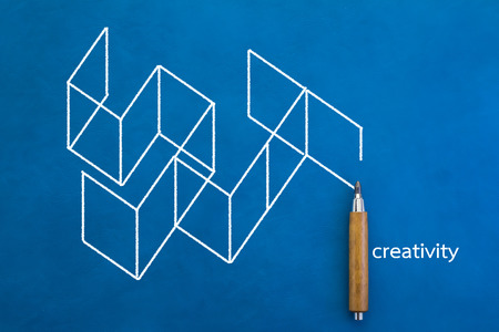 creativity concept drawing on blue background with wood pencil