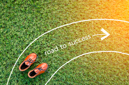 toy leather shoe on grass field texture background ROAD TO SUCCESS CONCEPTの写真素材