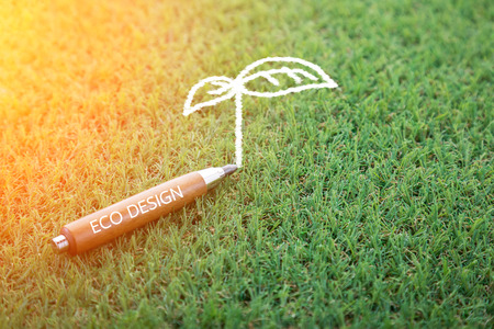 eco design concept with pencil and tree doodle on green field with copy-space for your ideaの写真素材