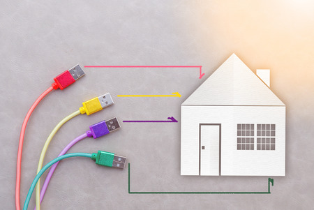 Network cable with house paper cut smart home concept on grey Backgroundの写真素材