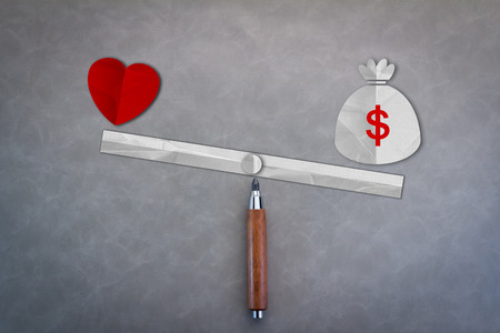 Balance between heart (love) and money  design / Love is more valuable than money conceptの写真素材