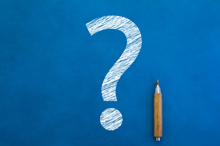 white drawing question mark icon on blue board backgroundの写真素材