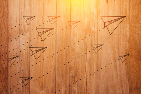 challenge concept with rocket paper doodleon wooden background with light flare effectの写真素材