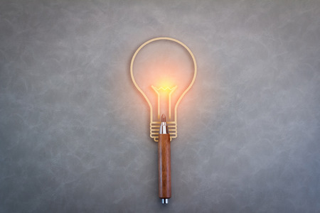 Creative ideas icon with a pencil and a lightbulb as a symbol of creativity and innovation and a spark of talentedの写真素材