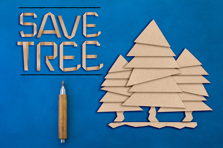 save tree concept with text and tree shape paper cut flat style on blue leather backgroundの写真素材