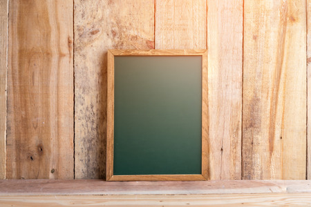 empty chalkboard with free copy space on rustic wooden plank creativity ideas conceptの写真素材