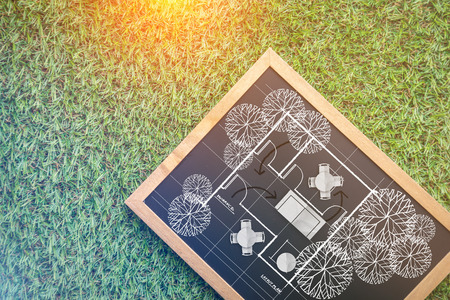 doodle of house plan on chalkboard and grass background home design concept