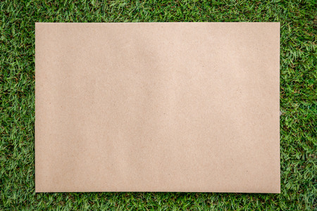 recycle paper with free copy space for your text on green grass texture backgroundの写真素材