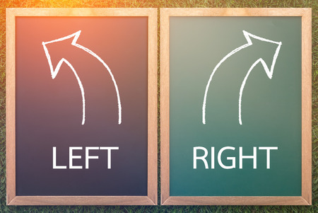 right left and arrow drawn with chalk on a blackboard life decision conceptの写真素材