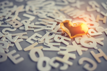 Valentine day. golden heart on a background of wood alphabet. Valentine's Day.の写真素材