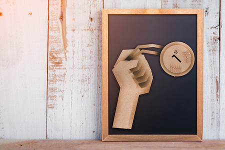 Winning gold medals paper cut on chalkboard on rustic wooden plank  business success conceptの写真素材
