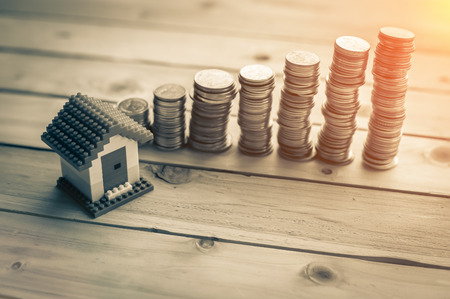 House Of Model With Coins On Wooden Table business asset conceptの写真素材
