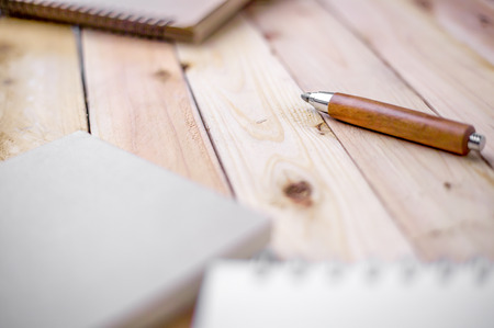 Open Vintage Sketchbook and Notebook with Pencil on Old Wooden Tableの写真素材