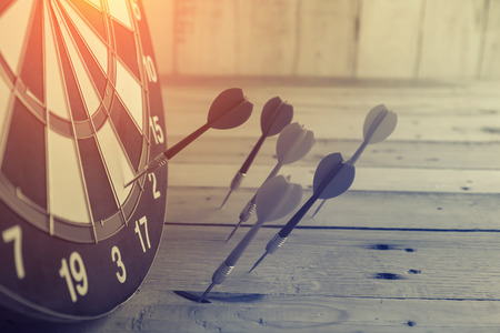 Success hitting target aim goal achievement concept background - dart in bull's eye close up