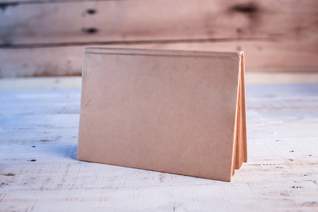 blank sketchbook on wooden background.jpgの写真素材