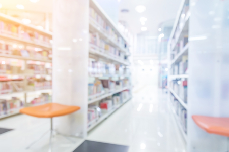 bookshelf and table desk in library, education abstract blur defocused backgroundの写真素材