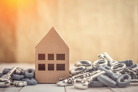 Concept image for new home with shiny house keys on a white wooden background. Copy space.house business conceptの写真素材