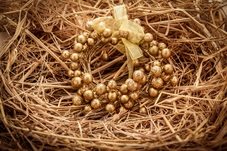 Christmas decorations on the table. The nest of Christmas tree decorations