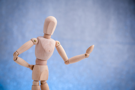 Wooden dummy showing product, space to insert text or designの写真素材